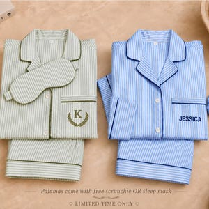 May include: Two sets of button-down pajamas with long sleeves and pants, one in light green and white stripes with a sleep mask and embroidered letter K, the other in blue and white stripes with a blue scrunchie and the name JESSICA embroidered.
