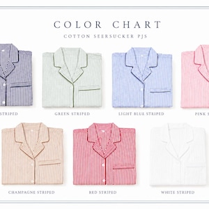 May include: A color chart for cotton seersucker pajamas featuring seven folded shirts with notched collars and chest pockets. The colors include navy, green, light blue, pink, champagne, red, and white stripes, with text labels below each shirt.