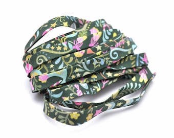 Cotton bias binding with a multicolored music and outdoor café theme on a green background