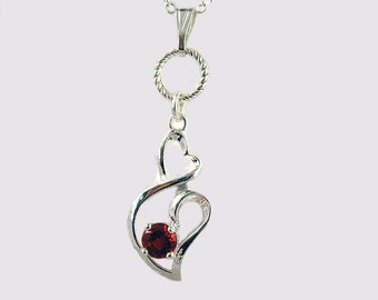 Heart on heart of silver and ruby - twisted ring