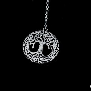 May include: A silver pendant necklace featuring a Celtic knot design with a tree of life motif in the center.