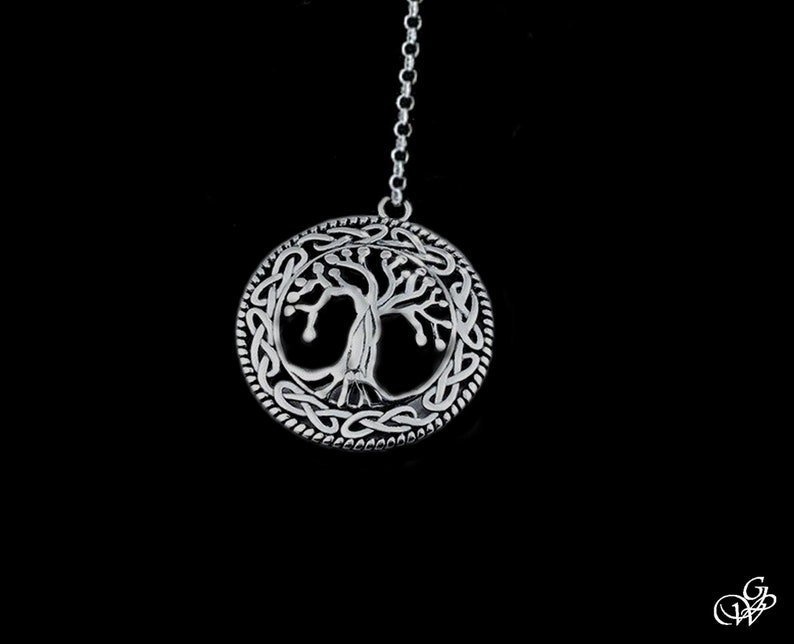 May include: A silver pendant necklace featuring a Celtic knot design with a tree of life motif in the center.