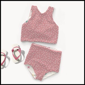 May include: Pink polka dot swimsuit with a halter top and high-waisted bottoms. The swimsuit has a white polka dot pattern and a white lining with a starfish design.