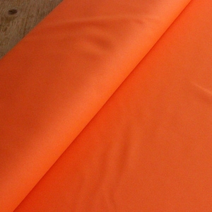 May include: A bright orange fabric, folded in half, with a smooth texture.