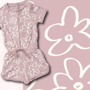 May include: A dusty rose-colored baby onesie with a white floral pattern. The onesie has short sleeves and a drawstring waist.
