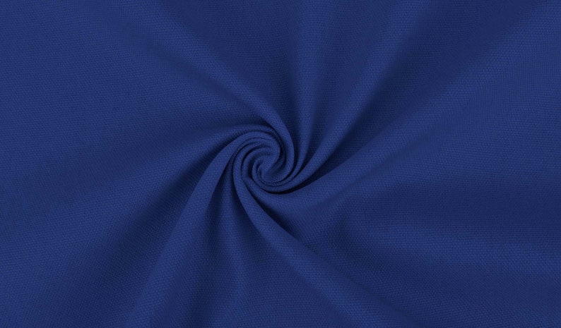 May include: A close-up of a smooth, blue fabric with a swirling pattern. The fabric is soft and has a subtle texture.
