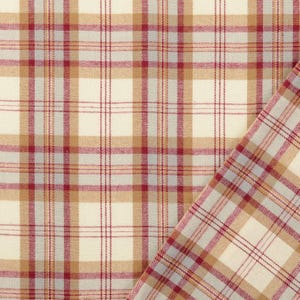 May include: Cream-colored plaid fabric with a pattern of red, tan, and gray lines. The fabric is folded over, revealing the pattern on both sides. The fabric has a woven texture.