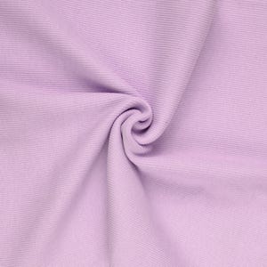 May include: A close-up shot of a lavender fabric with a ribbed texture. The fabric is gathered and swirled, creating a soft, flowing appearance. The color is a light, pastel purple, and the fabric appears to be a knit or similar material.