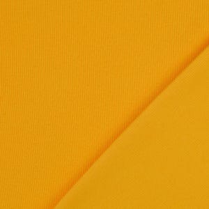 May include: Close-up of a vibrant, golden-yellow fabric with a ribbed texture. The fabric is folded diagonally, revealing a smooth, flat surface on the right side. The material appears to be a knit or woven textile, suitable for apparel or home decor.