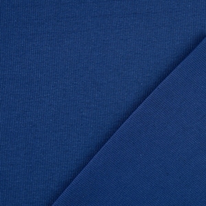 May include: A close-up shot of two pieces of blue fabric. The fabric on the left has a ribbed texture, while the fabric on the right is smooth. The colors are a deep, rich blue.