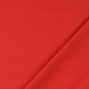 May include: A close-up of a vibrant red fabric with a ribbed texture. The fabric is folded diagonally, revealing the texture and color variations. The material appears to be a knit or similar textile.