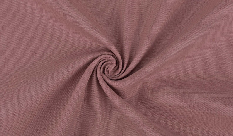 May include: A close-up of a soft, textured fabric in a dusty rose color. The fabric is folded and draped, creating a smooth, flowing effect.