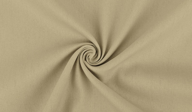 May include: Close-up of a beige fabric with a textured weave. The fabric is folded and twisted, creating a swirling pattern.