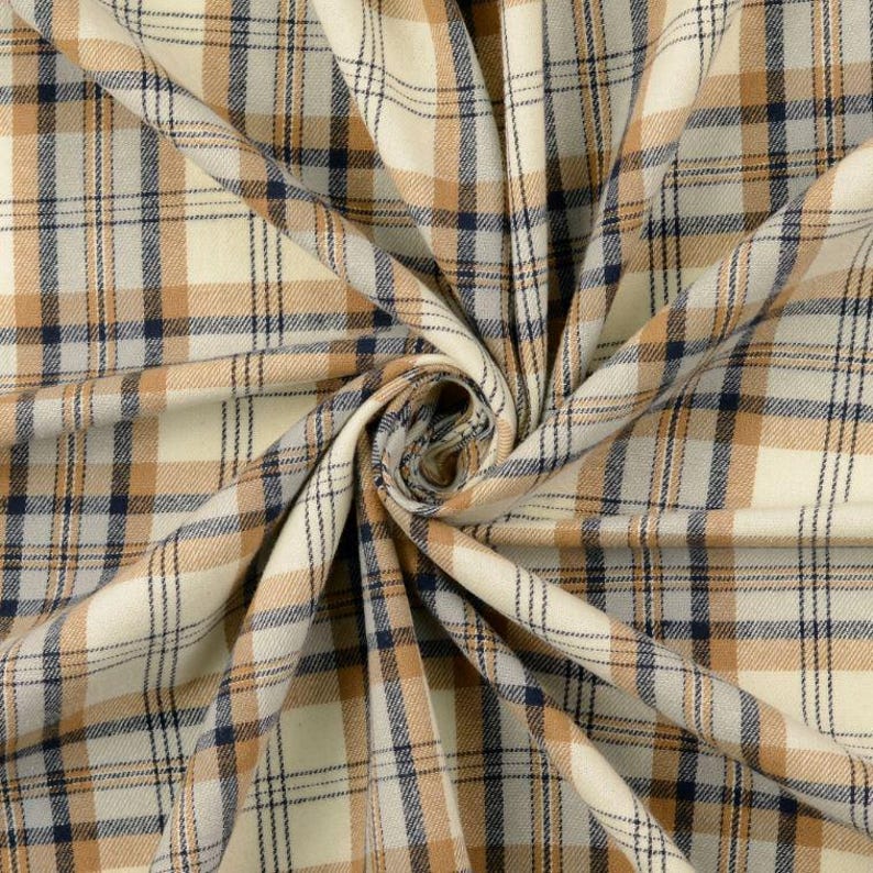 May include: Close-up of a beige, brown, and navy blue plaid fabric. The fabric is tightly woven with a classic plaid pattern. The fabric is folded and draped, showing the texture and color variations.
