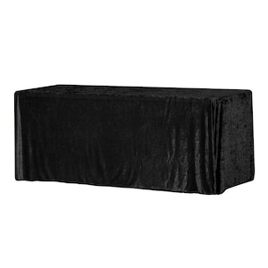 Puede incluir: Mantel de mesa de terciopelo negro con una textura suave y lujosa. El mantel está drapeado sobre una mesa y tiene un ligero brillo.