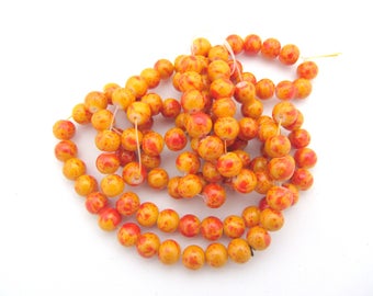 Lot de 10 perles en verre rondes oranges rouges