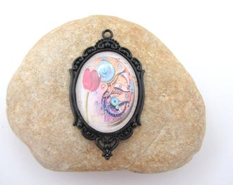 A black pendant with glass cabochon steampunk cameo