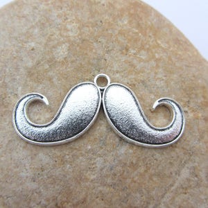 A charm, a pendant, a big mustache, of color silver