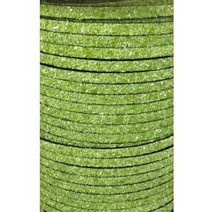 May include: A stack of round, lime green, textured discs with thin black lines between each layer. The discs have a speckled appearance and are tightly packed together, creating a cylindrical shape. The overall color is a vibrant, bright green.