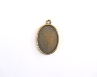 An oval pendant, glass cabochon support, tan,  18 x 25 mm