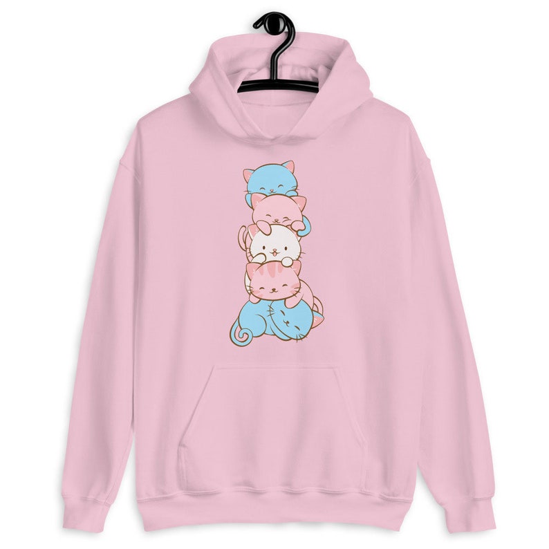 May include: Pink hoodie with a stack of four cartoon cats in different colors. The cats are stacked on top of each other, with the smallest cat on the bottom and the largest cat on top. The cats are all looking at the viewer.