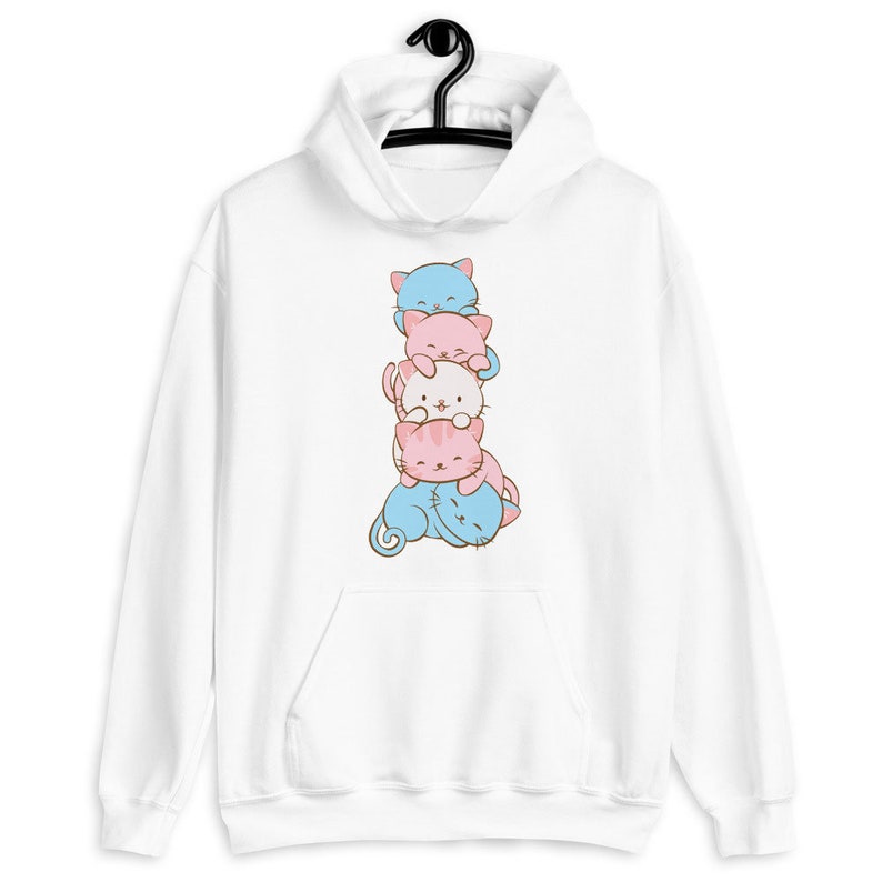 May include: White hoodie with a stack of four cartoon cats in different colors. The cats are stacked on top of each other, with the blue cat on top and the pink cat on the bottom.