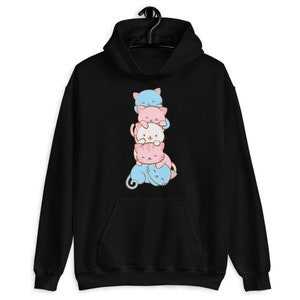 May include: Black hoodie with a stack of four cartoon cats in blue, pink, and white colors. The cats are stacked on top of each other, with the bottom cat's tail curled around the side.