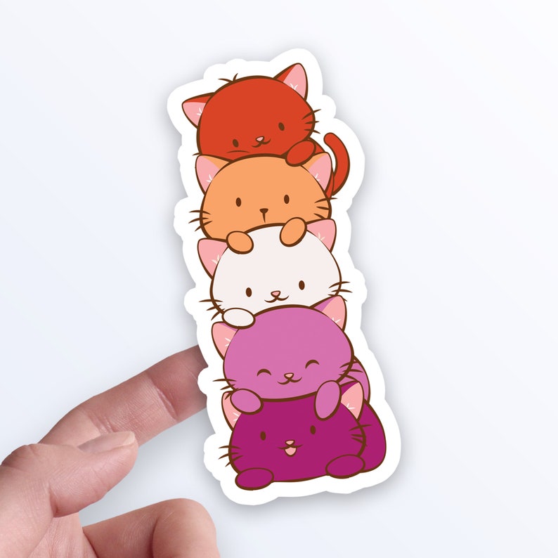 May include: A stack of five cartoon cats in a rainbow color scheme. The cats are stacked on top of each other, with the red cat on top and the purple cat on the bottom. The cats are all smiling and have their paws up in the air.