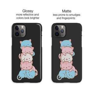 May include: A black phone case featuring a stack of five cartoon cats. The cats are pink, blue and white. The case is available in glossy or matte finishes.