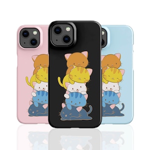May include: Three phone cases in pink, black, and light blue, each featuring a stack of cartoon cats. The cats are in various colors, including orange, yellow, white, and blue. The cases are designed for a smartphone.