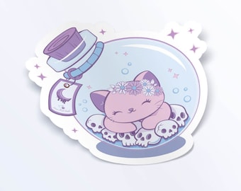 May include: A sticker depicting a pink cat with a flower crown inside a glass bottle, resting on skulls. The bottle has a purple stopper and a tag with a crescent moon design. The sticker has a light blue and purple colour scheme.