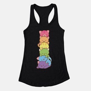 May include: Black tank top featuring a stack of six cartoon cats in various colors: pink, orange, yellow, green, blue, and purple. The cats are smiling and stacked on top of each other. The tank top has a racerback design.