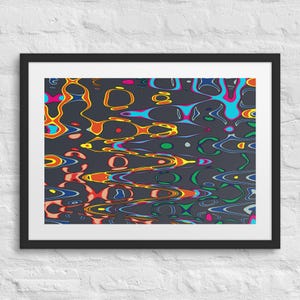 May include: Abstract art print in a black frame. The artwork features a dark grey background with colourful, flowing shapes in shades of orange, yellow, blue, green, and pink. The design has a wavy, liquid-like appearance.