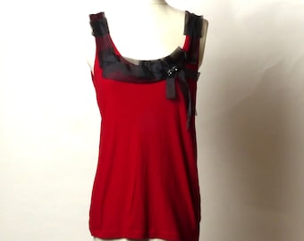 May include: A red sleeveless top with a black sheer bow detail at the neckline.