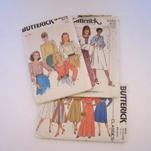 Puede incluir: Tres sobres de patrones de costura Butterick con ilustraciones de varias blusas, faldas y vestidos. Los sobres están etiquetados con los números 4219, 5325 y 6510, mostrando diversos estilos de prendas, largos de manga y siluetas de falda.