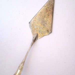 May include: A set of three ceramic mugs with a speckled, matte finish. The mugs are in shades of cream, light gray, and dark gray. Each mug has a simple, minimalist design and a rounded handle.