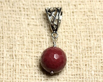 May include: A silver pendant with a decorative filigree design and a round, dark red gemstone.