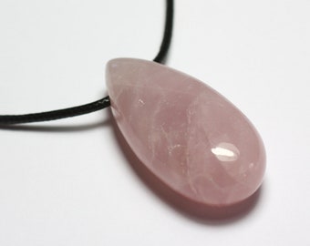 May include: A pale pink rose quartz pendant on a black cord necklace. The pendant is smooth and polished, with a teardrop shape.