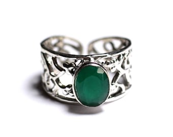 May include: A silver ring with an intricate design and a large oval green gemstone.