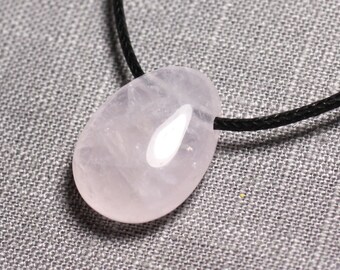 May include: A pale pink rose quartz pendant on a black cord necklace.