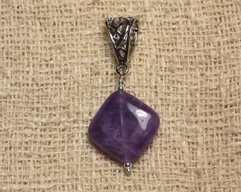 May include: A purple amethyst gemstone pendant with a silver filigree bail. The pendant is on a beige fabric background.