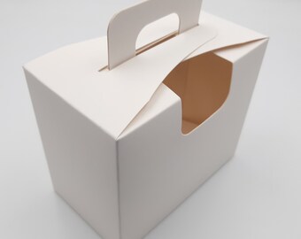 May include: White cardboard box with a cut-out handle and a window on the front. The box is empty.