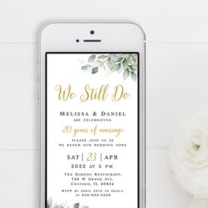 May include: A smartphone screen displaying a wedding anniversary invitation with green foliage and gold text. The invitation reads "We Still Do" and includes the couple's names, the date, time, and location of the event.