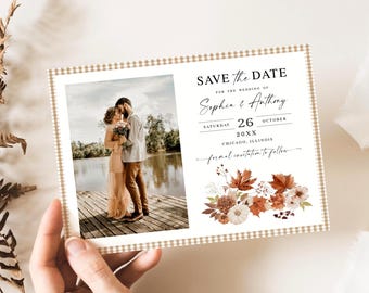 May include: A wedding save-the-date card with a photo of a couple. The card has a beige gingham border and text: "Save the Date" for Sophia & Anthony, October 26, 20XX, Chicago, Illinois. Floral design with autumn leaves.