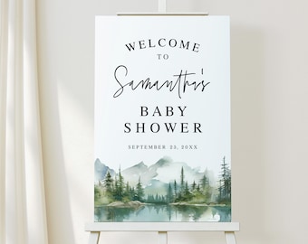 Peut inclure: Panneau blanc sur chevalet avec l'inscription "Welcome to Samantha's Baby Shower" en écriture noire. La date, le 23 septembre 20XX, est en dessous. Le bas présente un paysage aquarelle de montagnes, d'arbres et d'un lac.