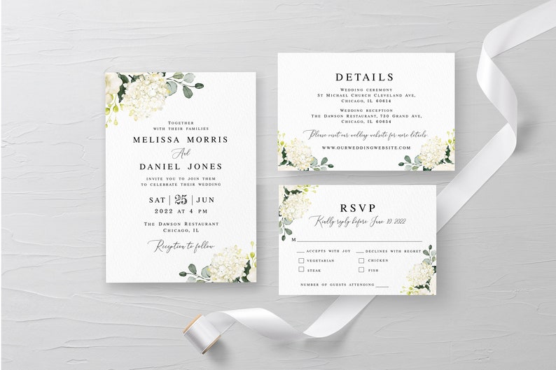 May include: Wedding invitation suite with white hydrangea floral design. The invitation card features the names Melissa Morris and Daniel Jones, the wedding date, and the location. The details card includes the wedding ceremony and reception locations. The RSVP card has a section for guests to indicate their attendance and meal preference.