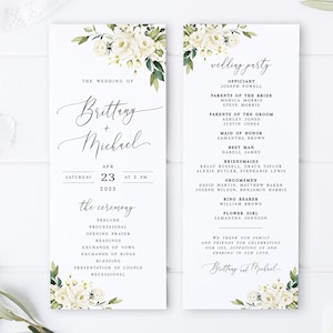 May include: Wedding program with floral decorations, listing the names "Brittany + Michael" and the date "Apr 23, 2022". The program details the ceremony order and wedding party, with a clean, elegant design.