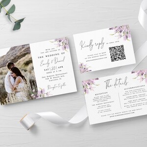 May include: Wedding invitation suite with a floral design. The invitation features a photo of a couple in a field, the text "The Wedding of Emily & Daniel", and the date "Sat 23 Apr 2023". The RSVP card includes a QR code and the text "Kindly reply by April 15th". The details card includes the text "The details" and information about the reception and accommodations.