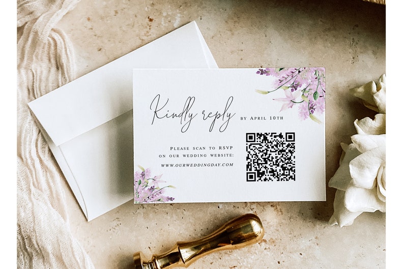 May include: A white RSVP card with a floral design and a QR code. The text on the card reads "Kindly reply by April 10th. Please scan to RSVP on our wedding website: www.ourweddingday.com"