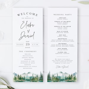 May include: Wedding ceremony program with a watercolor illustration of a forest scene with mountains and a lake. The program lists the order of events for the ceremony and includes the names of the wedding party.